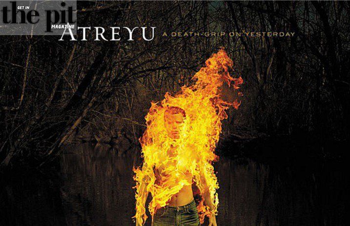 Album cover of atreyu "a death-grip on yesterday" featuring a man engulfed in flames standing in a swampy area.