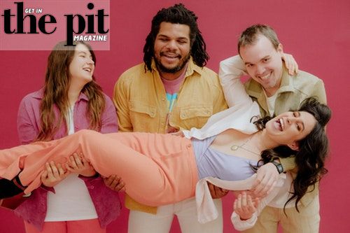 Four friends laughing and having fun, with one man carrying a woman in his arms, against a pink background with "Mannequin Pussy" magazine text overlay.