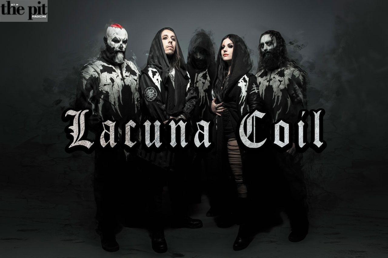 Four members of Lacuna Coil in dramatic gothic-style costumes, posing against a dark background with the band's logo in front.