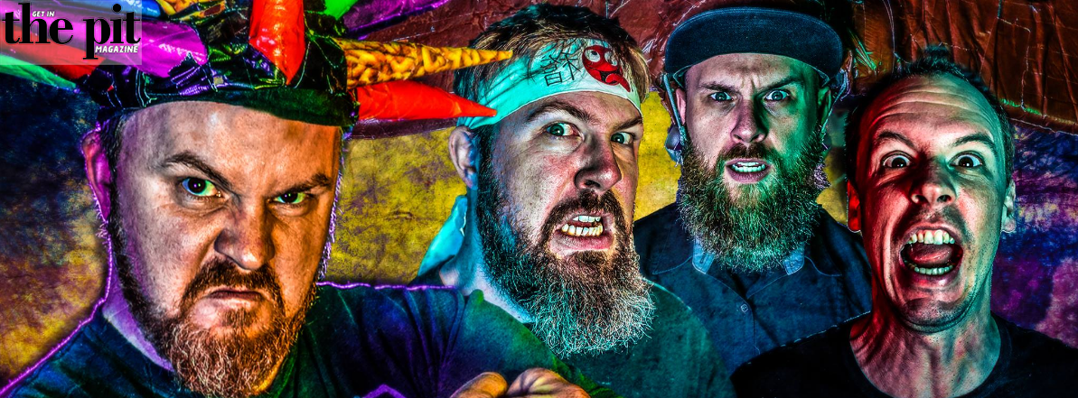 Four intense men with beards in colorful, vibrant attire making animated expressions against a graffiti backdrop with the Psychostick logo.