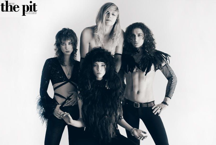 Four women in edgy rock fashion posing for a Starbenders band photo in a black-and-white studio setting.