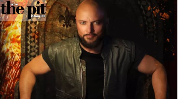 A bald man in a black leather vest stares intensely at the camera, with a fiery abstract background and text "Sweet Oblivion" at the top.