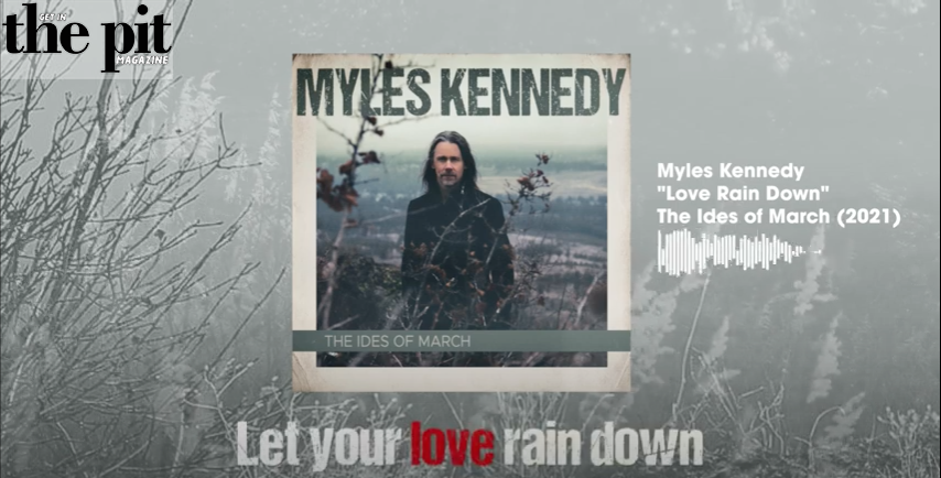 Promotional image for Myles Kennedy's song "love rain down" from "the ides of march" album, featuring the artist standing in a misty forest, displayed on a magazine cover.